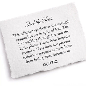 White card with engraved text about 'Feel the Fear' talisman by pyrrha