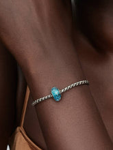 Load image into Gallery viewer, Bracelet with a blue gemstone on a wrist 
