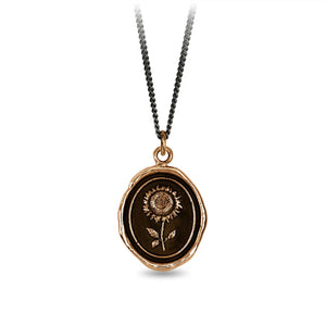 Necklace with a bronze pendant featuring an engraved design on a white background